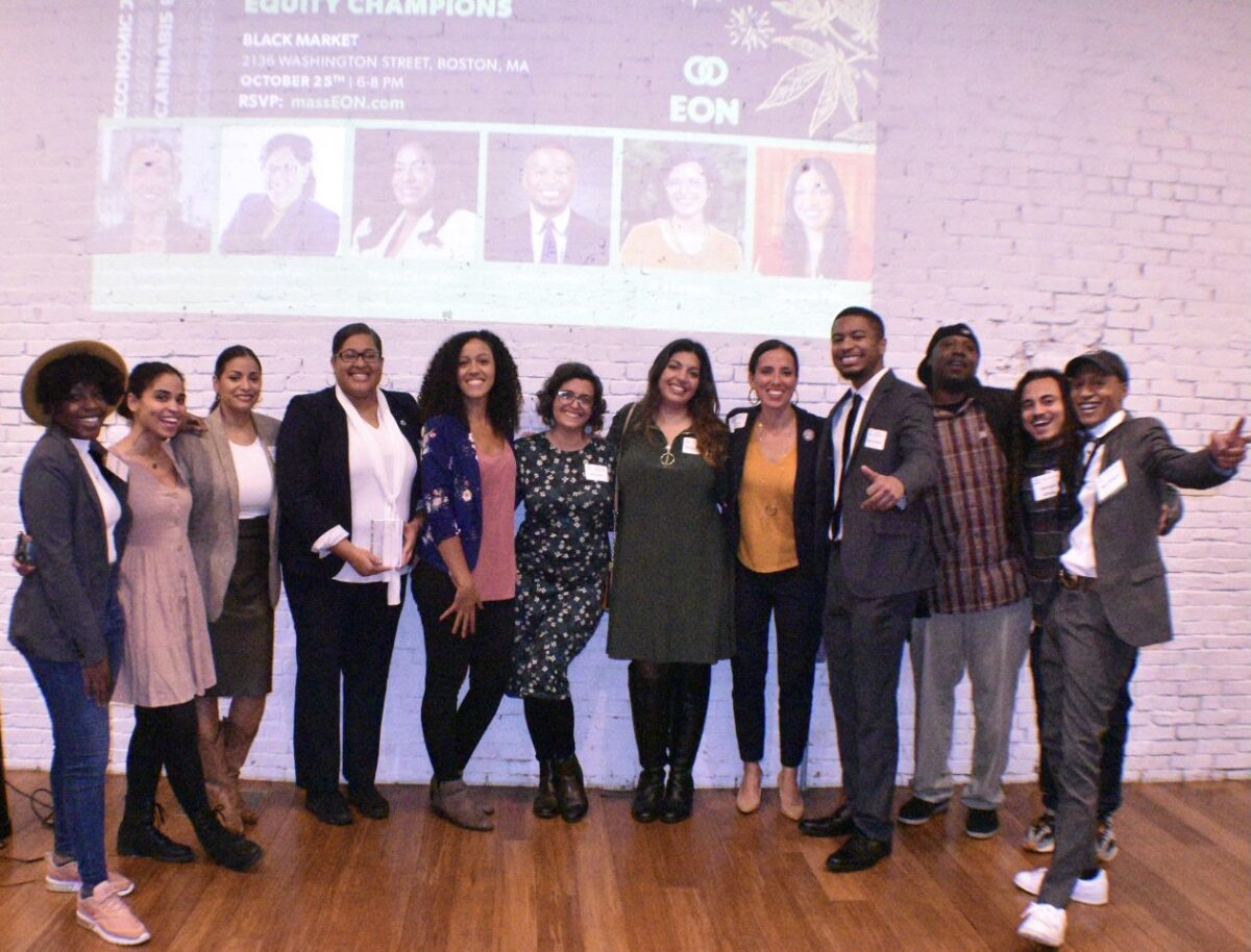 Picture of Equitable Opportunities Now team at 2022 Celebration of Equity Champions at Black Market in Roxbury. Image includes: - EON Lead Trainer Laury Lucien, - EON Programming Co-Chair Eve Marie Santana, - Cannabis Control Commissioner Nurys Camargo, - Rep. Chynah Tyler, - EON Co-Founder Shanel Lindsay, - Director of Business Strategy for the Mayor's Office of Economic Opportunity and Inclusion Alia Hamada Forrest, - EON Co-Founder and former Commissioner Shanel Lindsay, - Former Sen. Sonia Chang Diaz, - BECMA Policy and Advocacy Lead Darien Johnson, - EON Policy Co-Chair Armani Whitr - EON Media Director Ian Powell